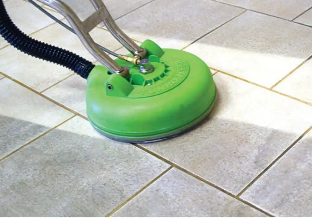 Professional hard floor cleaning technician using specialised equipment in Swansea home