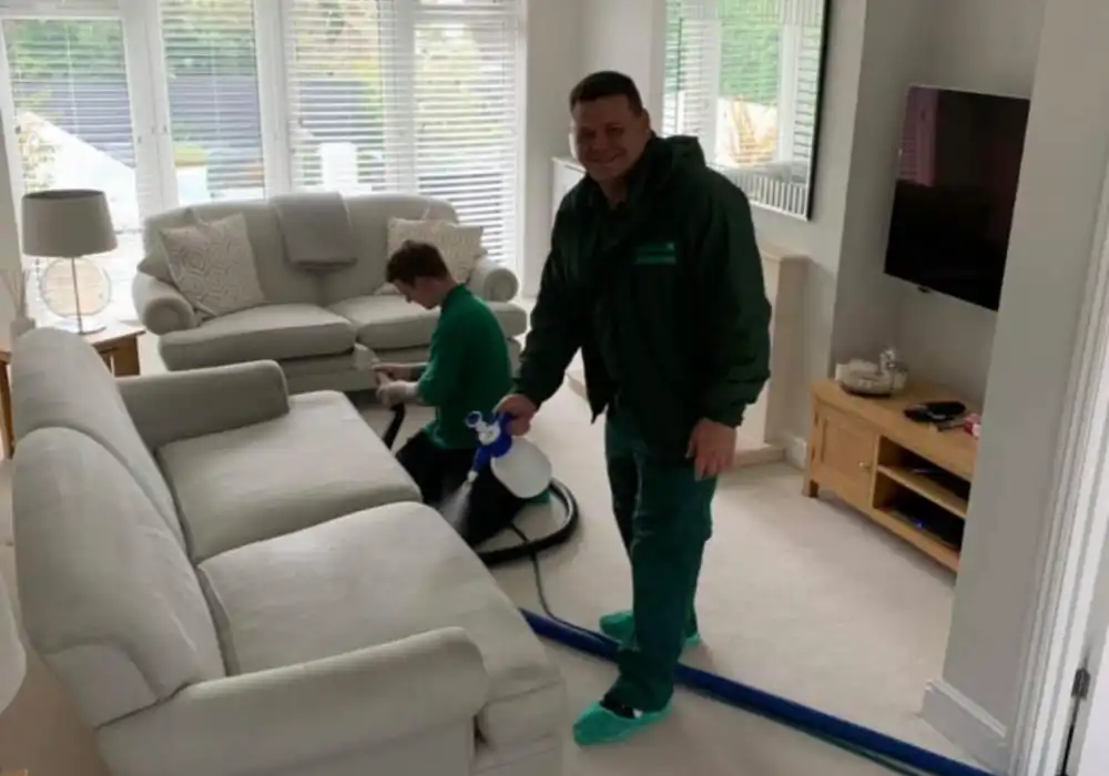 Professional upholstery cleaning team setting up in a Swansea home interior